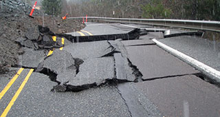 Road with earthquake or landslide damage requiring pavement rehabilitation