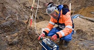 Engineer using a nuclear probe for soil analysis